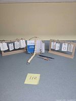 All items: two calendars, boxed wall shelf, bead keyring, crab figurine, pen
