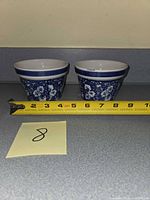 Front view of both blue and white ceramic pots