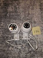 Two white POHAGANZE dome security cameras with mounts and cables