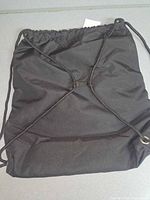 Back view of one Crosskix drawstring bag showing cinch cords and clip