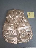 Front view of metallic rose gold padded dog jacket showing leg openings and velcro closure