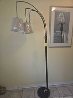 Full view of lamp showing three arms, two shades, base