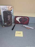 Group shot of all four items: coin jar box, wallet, crab holder with pen