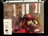 Full view of signed photo in sleeve with hologram