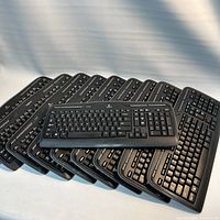 Stack of nine Logitech K330 keyboards