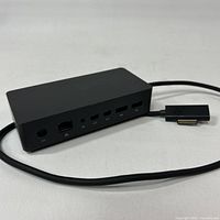 Front/side view of Microsoft Surface Dock with attached Surface Connect cable