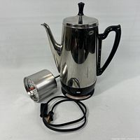Percolator with pump/basket and power cord displayed