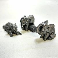 Three pewter elephant figurines front view