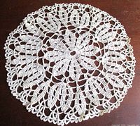 Full view of round crochet doily on table
