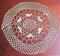 Full view of circular crochet doily showing color and pattern