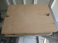 Top view of wooden press showing two wing-nut bolts