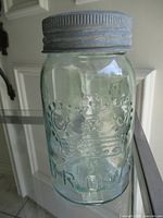 Full view of aqua Crown Mason jar with lid