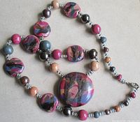 Necklace coiled to show variety of Picasso Jasper flat discs, round beads, metal spacers and clasp