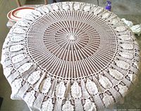 Full view of round crochet tablecloth on table