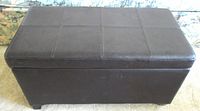 Front view of espresso brown upholstered storage ottoman bench showing rectangular shape and stitched top