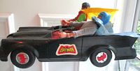 Side view of Batmobile with Batman and Robin figures seated