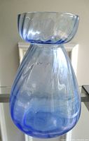 Front view of blue glass hyacinth vase showing optic swirl pattern and overall shape