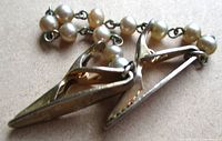 Close-up of clips showing faux pearls and metal jaws