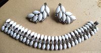 full set showing bracelet curved and both earrings
