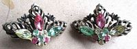 Frontal view of both earrings showing rhinestone arrangement and metal filigree