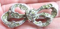 Front view showing bow design and rhinestone arrangement