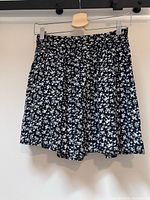 Front view of floral mini skirt on hanger