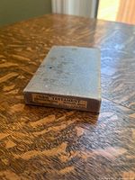 Spine label of slipcase showing New Testament pronouncing Minton 48mo