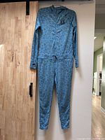 Full view of hooded one-piece long underwear hanging