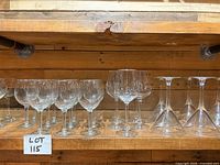 Various wine and martini glasses on wooden shelf