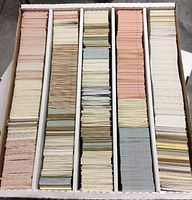 Top view of four-row card storage box filled with unsleeved sports cards