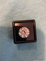 Round brilliant moissanite in black display box
