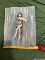 Front view of painting with tape measure showing width
