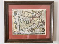 Full view of framed map showing wood frame, red mat, and entire print