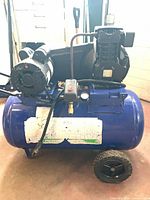 Left side view showing tank, pump, gauges, wheels