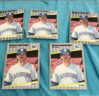 Fronts of five Edgar Martinez 1989 Fleer rookie cards laid out on blue cloth