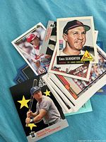 Top view of stacked baseball cards showing Enos Slaughter and Steve Sax cards