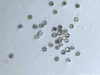 Scattered view of loose round diamonds showing size and quantity