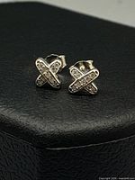 Front view of both sterling silver cross stud earrings showing CZ stones