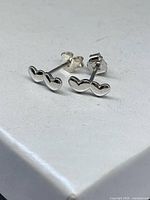 Stud earrings front view on box surface