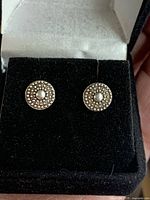 Front view of pair of sterling silver beaded circle stud earrings in display box