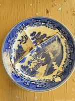 Top view of blue willow divided plate showing pattern and wear