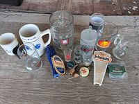 Overall view of 15 assorted barware items laid out on wooden surface