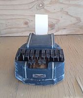 Front view of black Stenograph Reporter stenotype machine with paper inserted