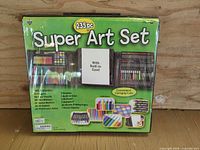 Front of packaged 235-piece Super Art Set showing case, contents overview and feature text