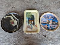 Front view of all three trays showing designs and overall condition