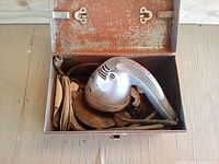 Open metal toolbox showing Craftsman sander and sanding discs