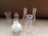 Group shot of six assorted glass lamp chimneys