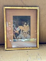 Full view of framed print showing image, frame, wear