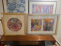Framed square collage and framed rectangular diptych on console