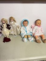 Four dolls side by side on surface